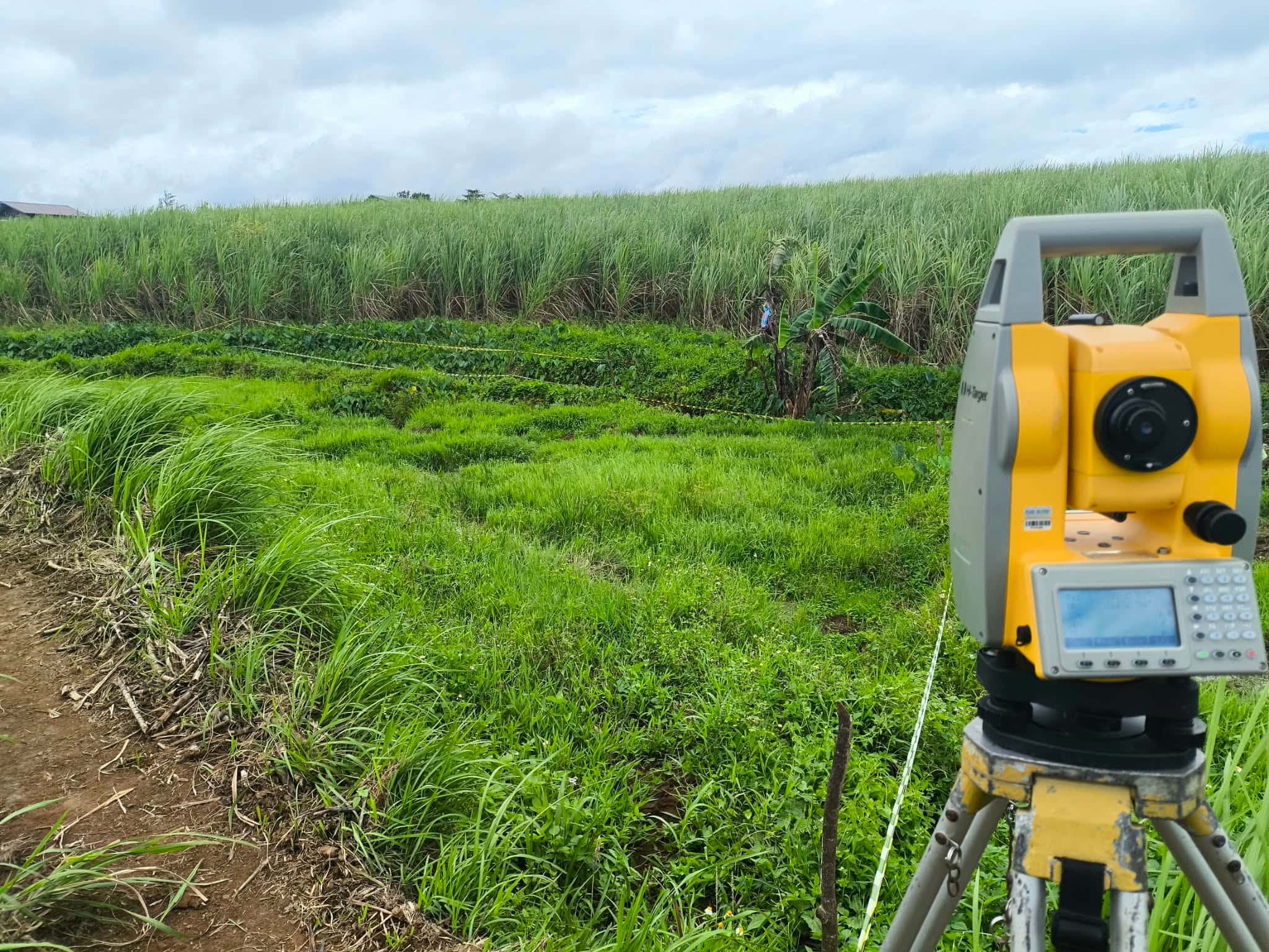 Field crew marking survey points on a hillside during a parcellary survey